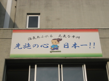 写真：看板「活気あふれる　元気な平洲　先施の心　日本一」
